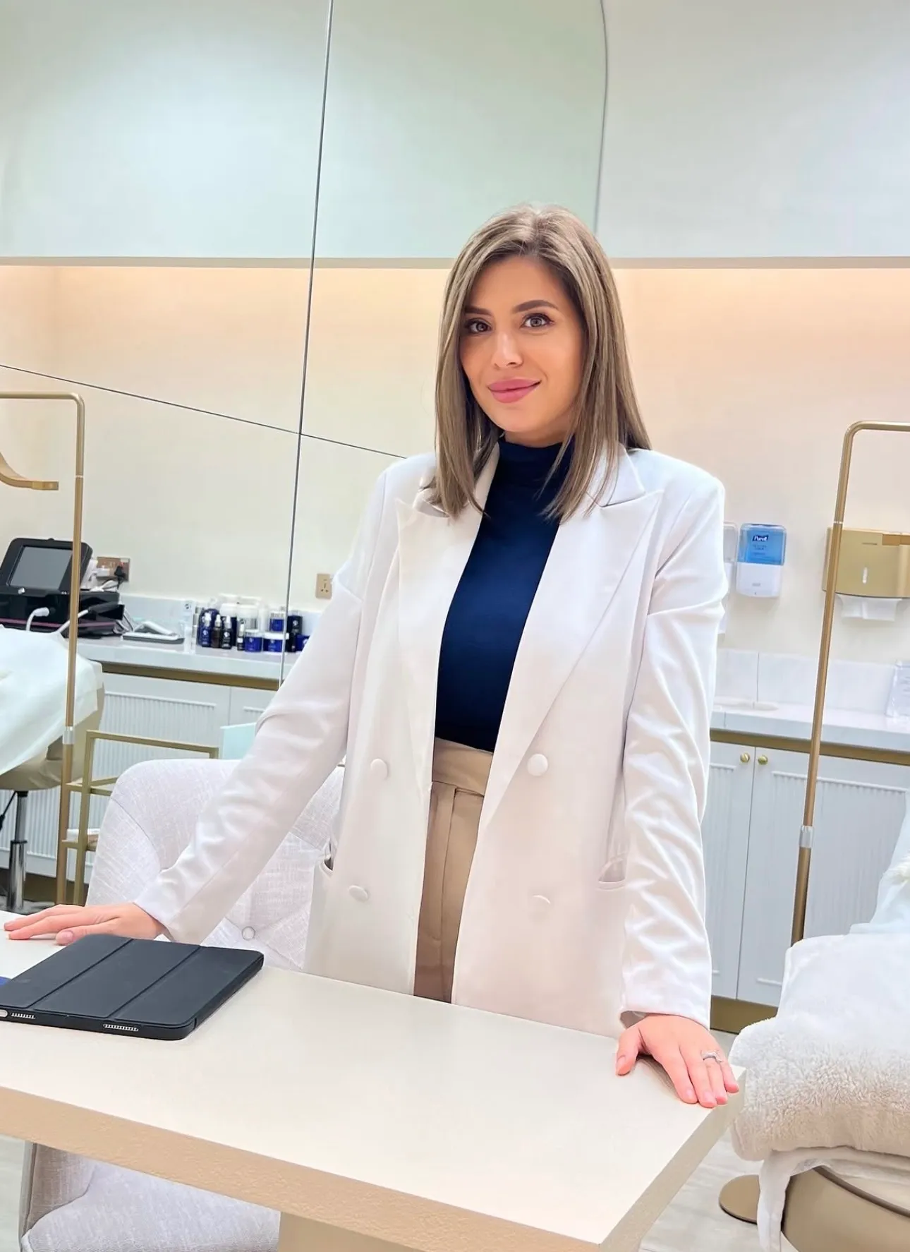 Andreea’s certificates laid out on a white table between pink roses: ITEC diplomas, Dubai training certificates, chemical peel, microneedling and dermaplaning certificates, and her beauty therapy diploma