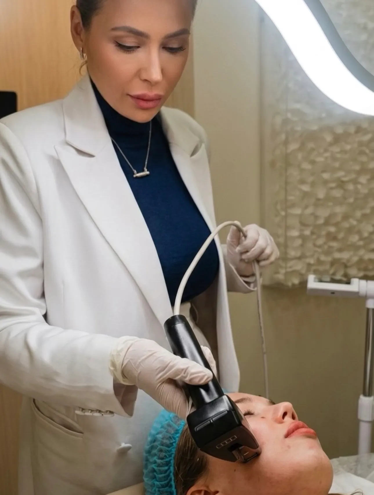 Andreea performing a facial treatment with a handpiece